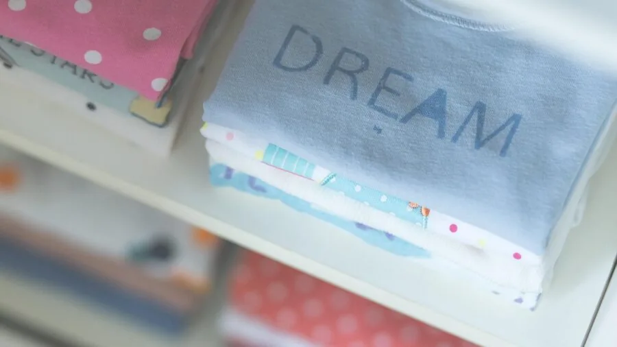 Neatly folded children's clothing stacked together, showing practical organization and storage of kids' apparel