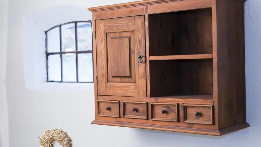 Neatly organized kitchen cabinet with stacked dishes and cookware showing efficient storage solutions