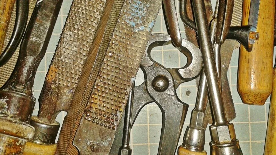 Neatly organized tools and hardware sorted in wooden drawer compartments for easy access
