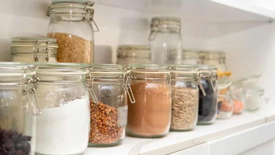 Neatly stacked food storage containers organized in a kitchen cabinet drawer