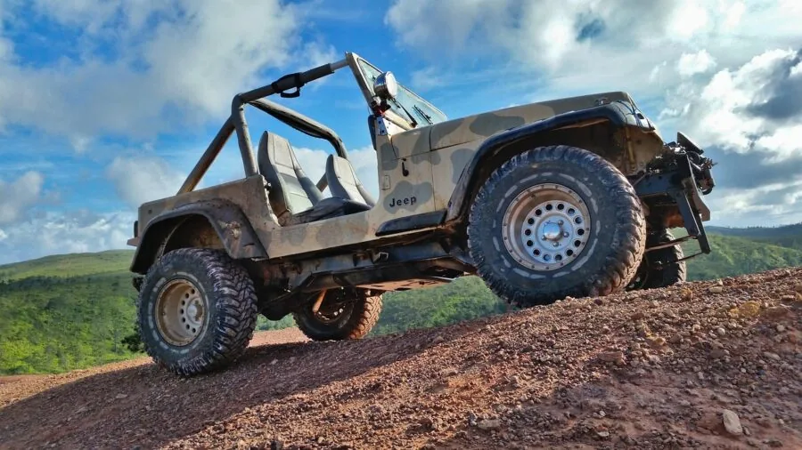 Off-road vehicle traction assistance in muddy terrain during outdoor recovery situation