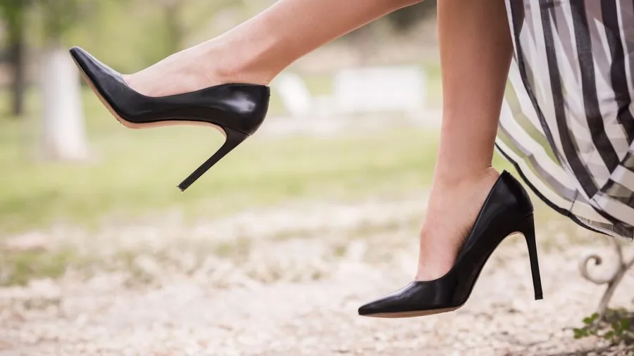 Older woman easily putting on slip-on walking shoes while sitting, demonstrating convenient footwear for mobility