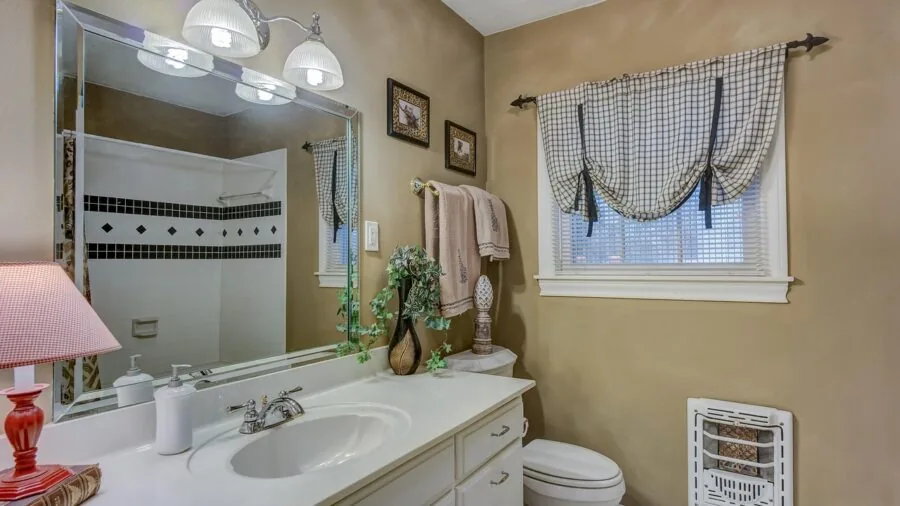 Open bathroom medicine cabinet displaying organized toiletries and personal care items on multiple shelves