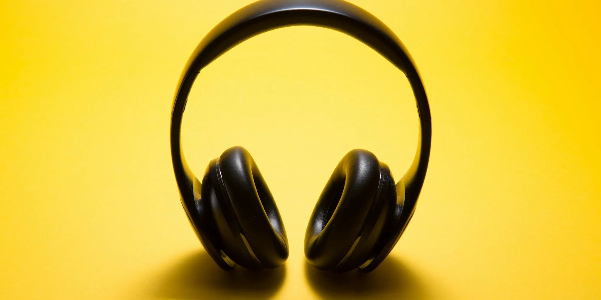 Open-ear headphones displayed on stand showing design and fit