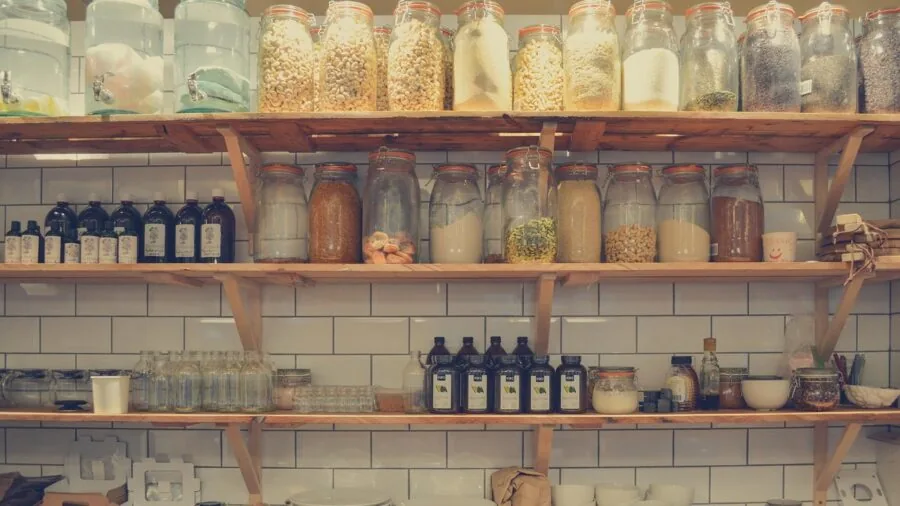 Organized bathroom medicine cabinet with neatly arranged pill bottles and storage containers in landscape view
