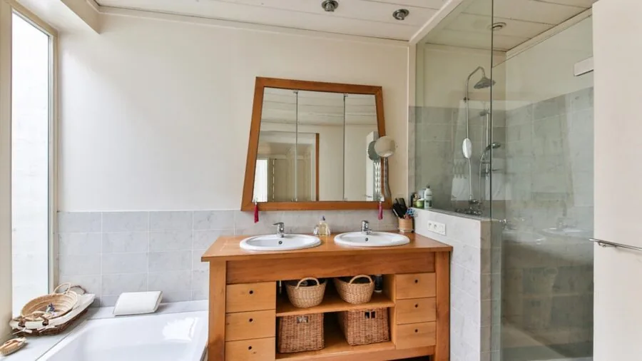 Organized bathroom shower wall with hanging storage solutions and hooks for cleaning tools