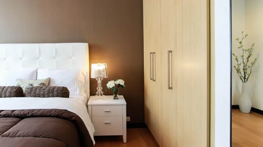 Organized bedroom nightstand with open drawer showing neat storage of personal items and bedside essentials