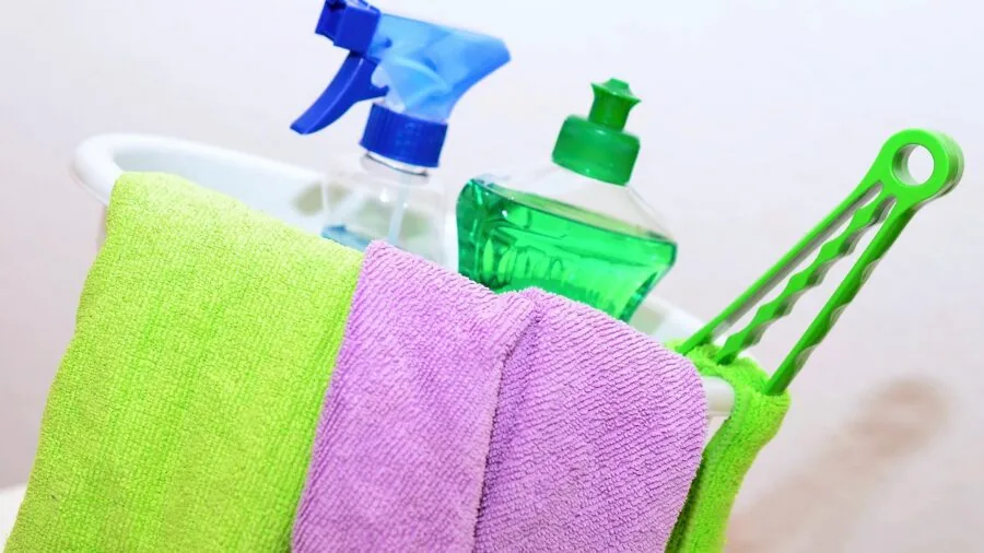 Organized cleaning caddy with spray bottles, gloves, and scrubbing tools neatly arranged on shelves
