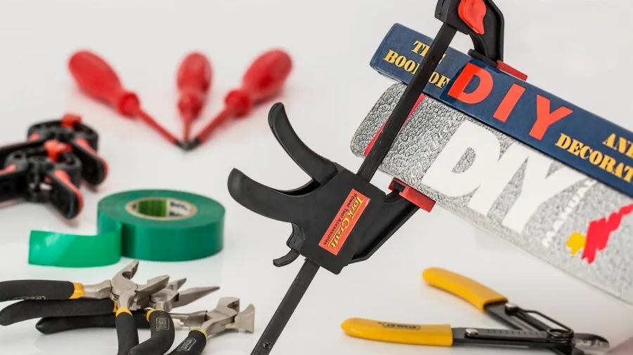 Organized collection of hand tools and hardware supplies arranged on a workbench for home improvement projects