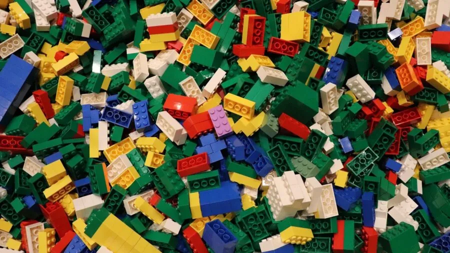 Organized colorful building blocks in storage containers, showing neat arrangement and organization system for toys