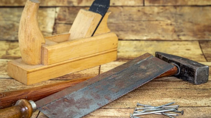 Organized DIY toolkit and supplies arranged on wooden workbench for home improvement projects