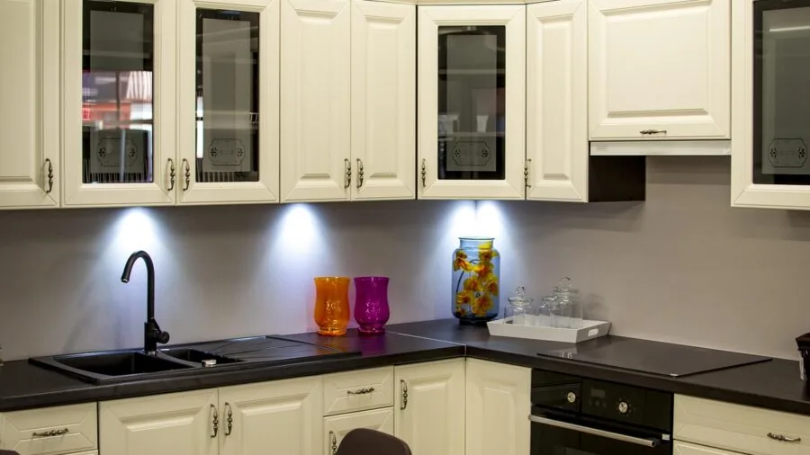 Organized kitchen countertop with various storage containers and baked goods in natural light