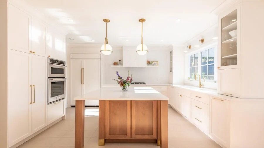Organized kitchen interior showing refrigerator placement and counter storage solutions in contemporary home