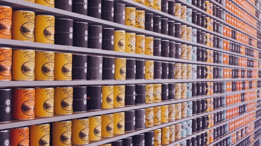 Organized kitchen pantry with labeled storage containers neatly arranged on shelves