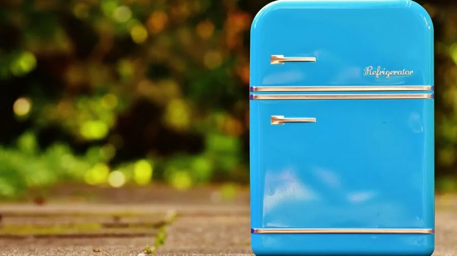Organized mini fridge with beverages and food items stored efficiently in a kitchen
