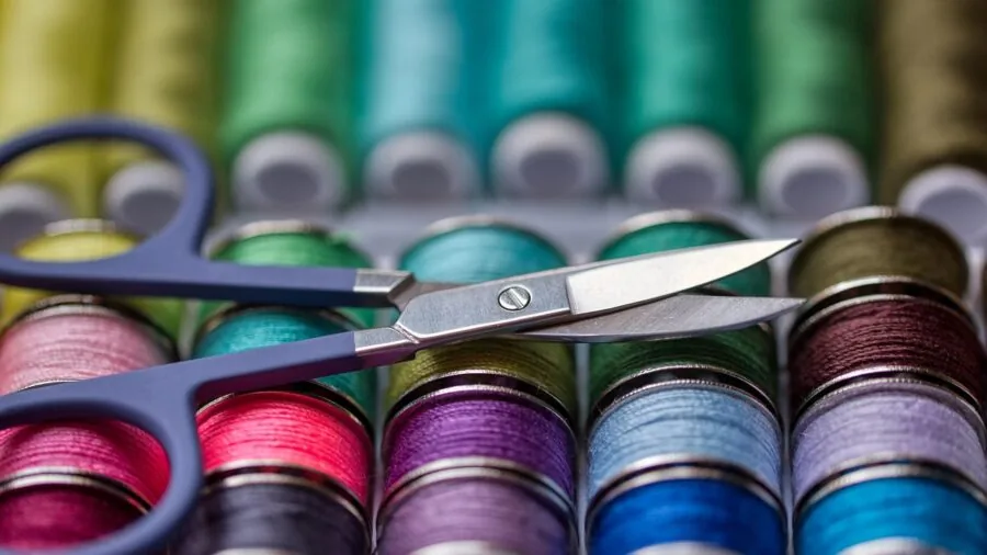 Organized sewing workspace with fabric scraps and tools on wooden table