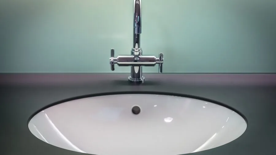Organized travel toiletries and hygiene items neatly arranged in a bright bathroom setting