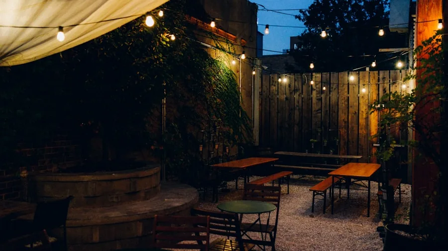 Outdoor patio with softly dimmed string lights creating warm ambiance over a gathering space