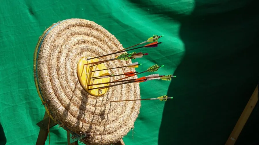 Outdoor shooter aiming at distant target with focused concentration during tactical training session