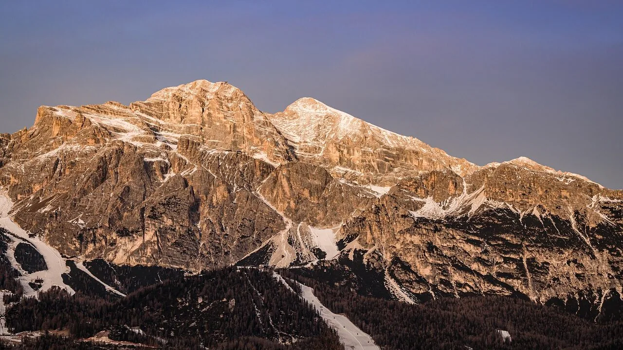 Pair of ski boots displayed on snowy mountain slope
