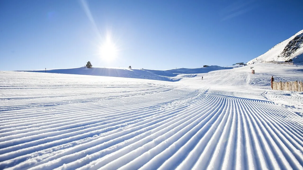 Pair of ski gloves displayed on snowy winter mountain background