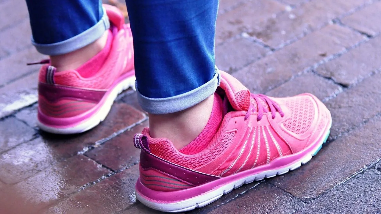 Pair of women's running shoes displayed on feet showing athletic footwear design