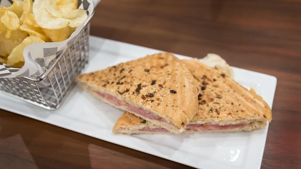 Panini press with grilled sandwich on kitchen counter