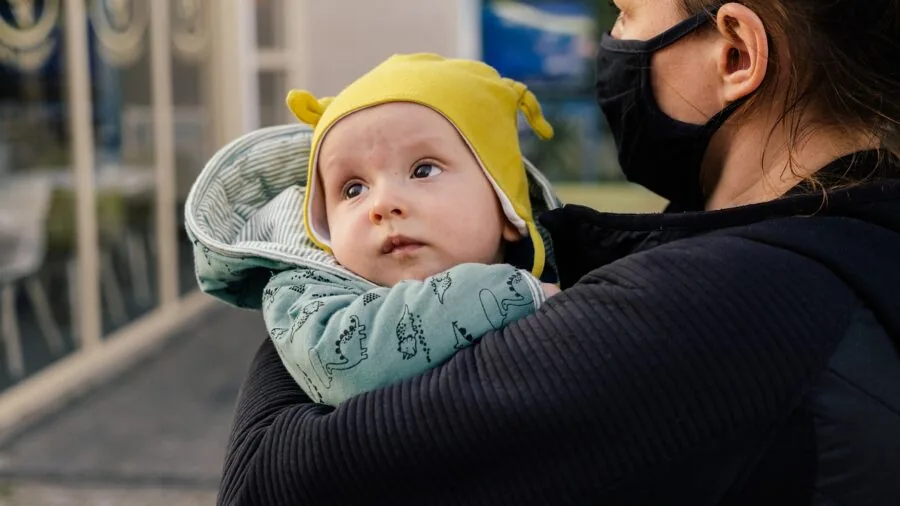 Parent carefully examining baby gear for safety standards and quality before purchase