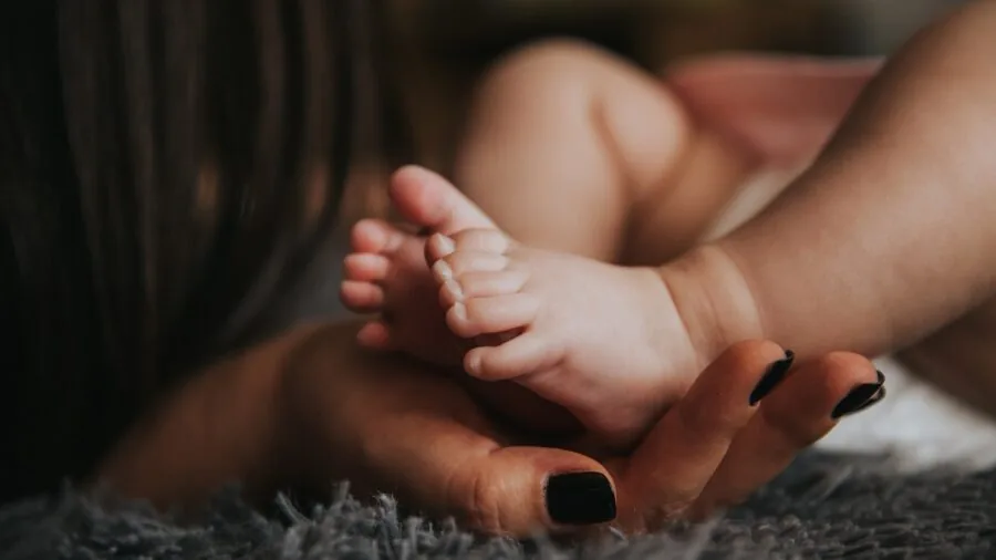 Parent carefully installing infant car seat in vehicle for safe travel with baby