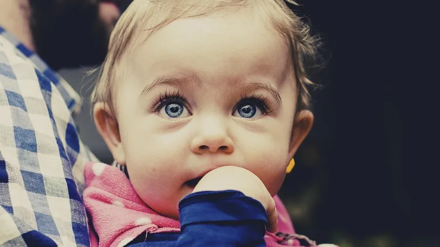 Parent carrying diaper bag and baby essentials while walking outdoors