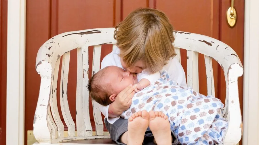 Parent changing baby's diaper at night, focusing on gentle skincare and protection during extended wear