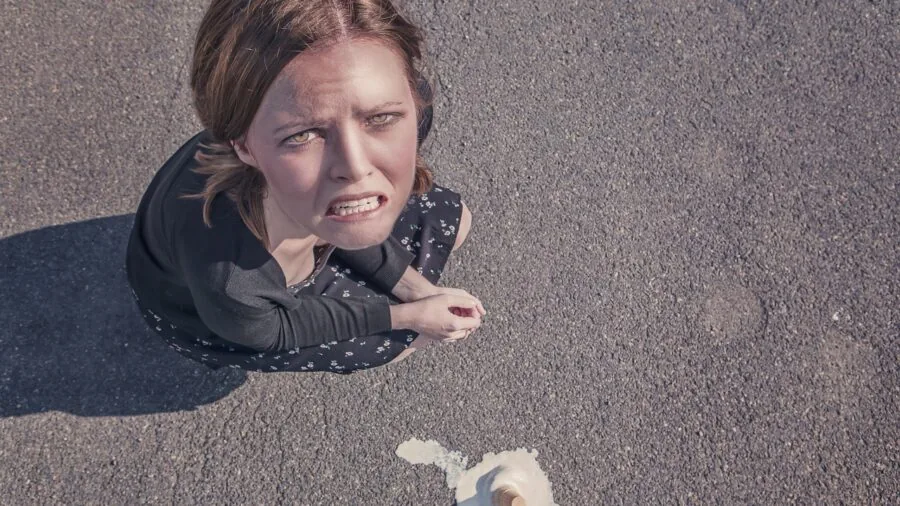 Parent cleaning up spilled liquid from baby item, demonstrating real-world durability needs for parenting gear