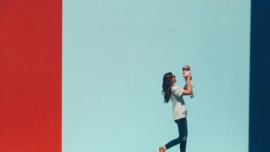 Parent evaluating different baby bottle choices while planning purchases for newborn care