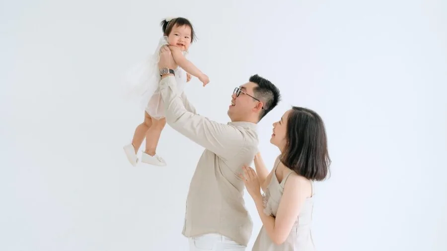 Parent folding and carrying a portable play mat while preparing for travel with baby gear