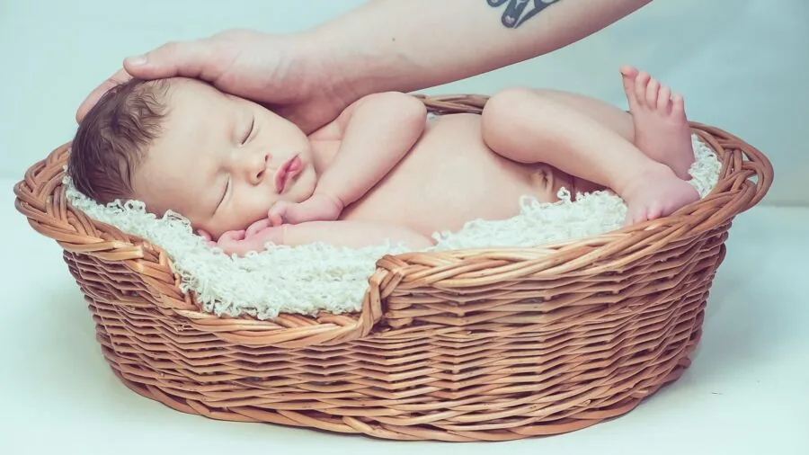 Parent gently washing baby's hair during bath time with soft water and mild cleanser