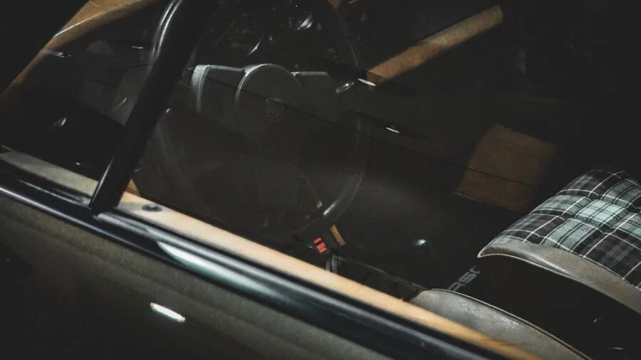 Parent installing child car seat in back seat of vehicle