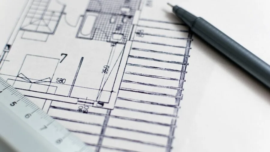 Parent measuring nursery floor space for furniture placement and room layout planning