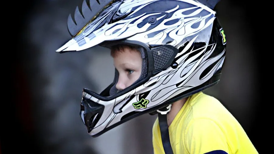 Parent measuring young child's head size for proper helmet fit selection