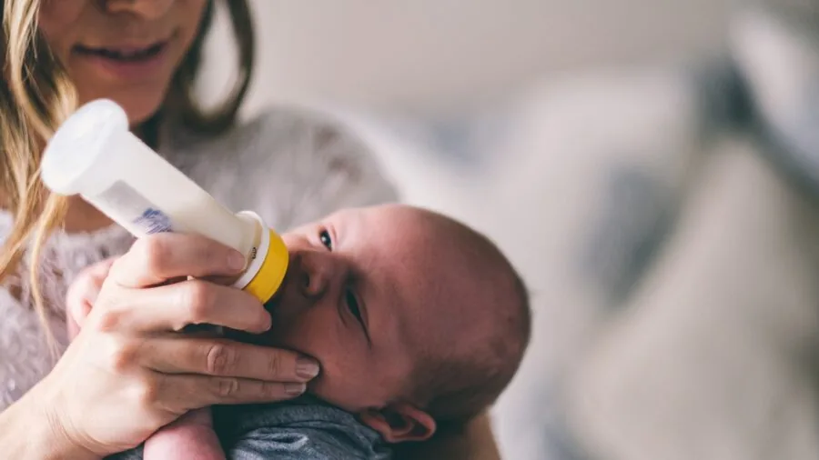 Parent monitoring baby room temperature and comfort while child sleeps peacefully