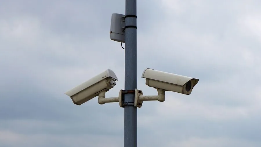 Parent monitoring home security system on smartphone, concerned about family safety and privacy