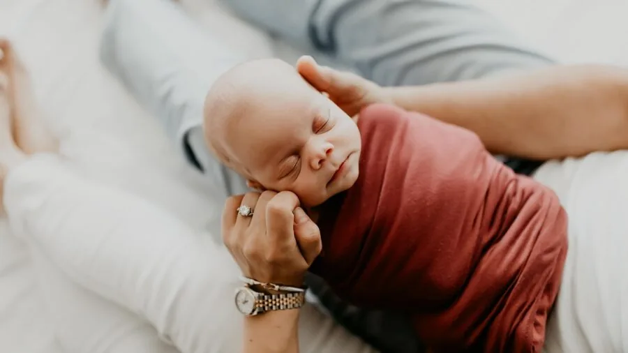Parent monitoring sleeping infant from distance using technology, peaceful nursery scene