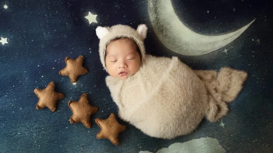 Parent monitoring sleeping infant in dark bedroom at night with soft lighting