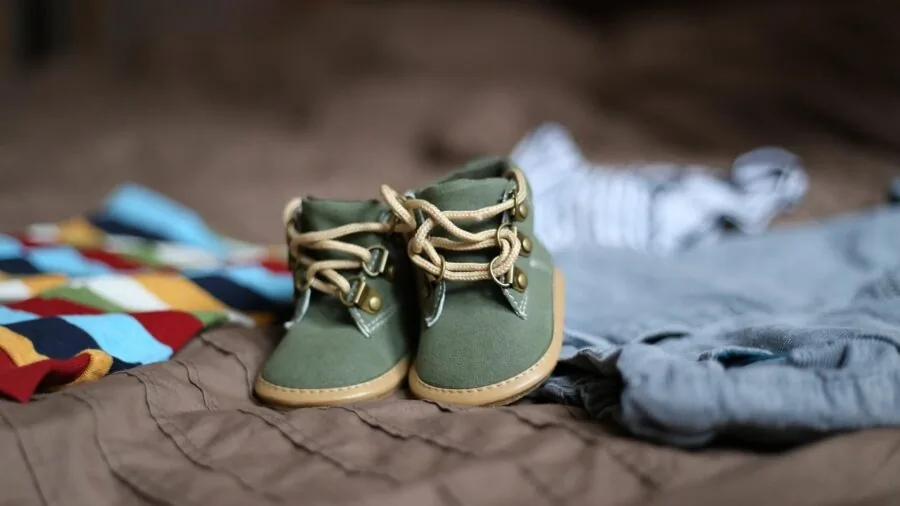 Parent organizing baby supplies in nursery showing practical storage solutions for daily use