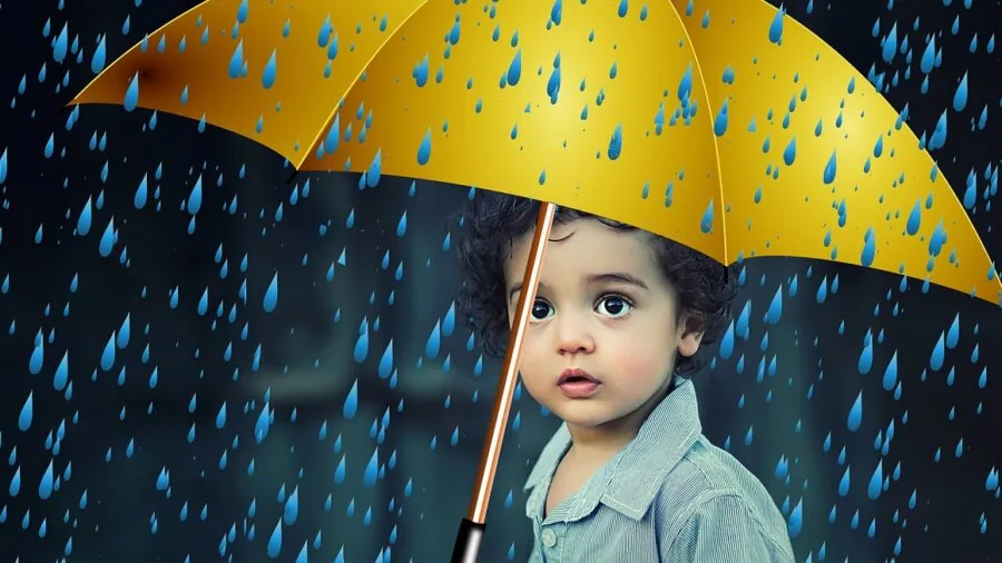 Parent protecting luggage from rain during family travel at airport or station