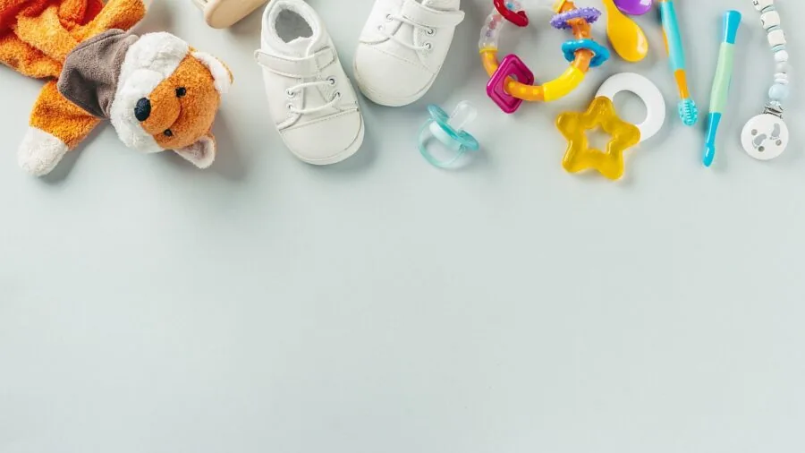 Parent reviewing budget options while planning nursery setup with crib and soft lighting