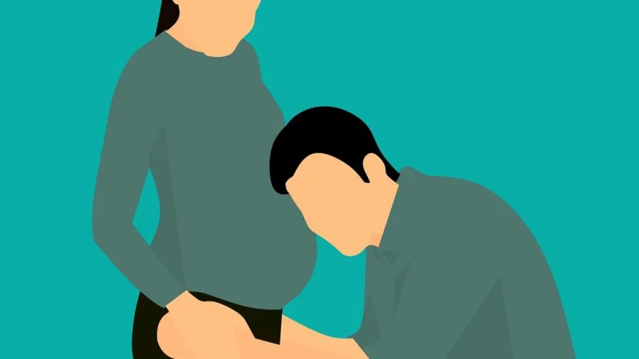 Parent supporting baby during tummy time on floor with pillow assistance