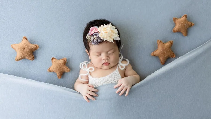 Parent using audio monitor while baby sleeps peacefully in crib at home