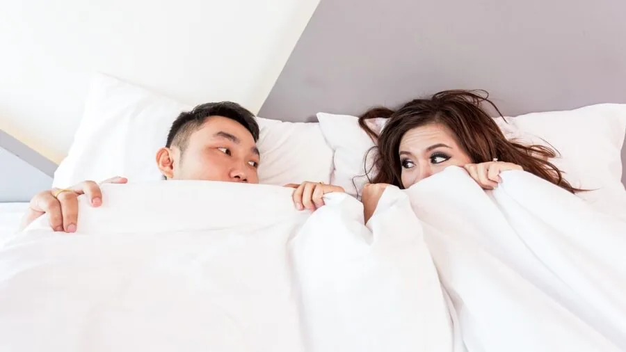 Partner sleeping undisturbed while other moves in bed, demonstrating motion isolation