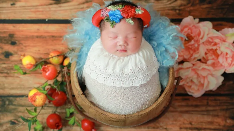 Peaceful infant sleeping soundly wrapped in soft bedding, illustrating proper baby sleep positioning and comfort