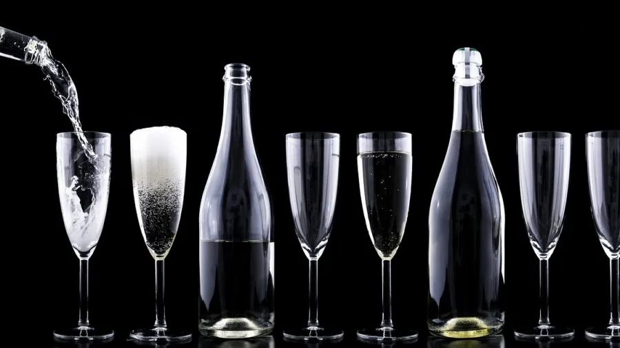 People clinking champagne flutes together at an elegant celebration or dinner party